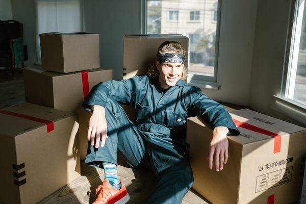 Person moving gracefully through an exercise sequence in a bright room.